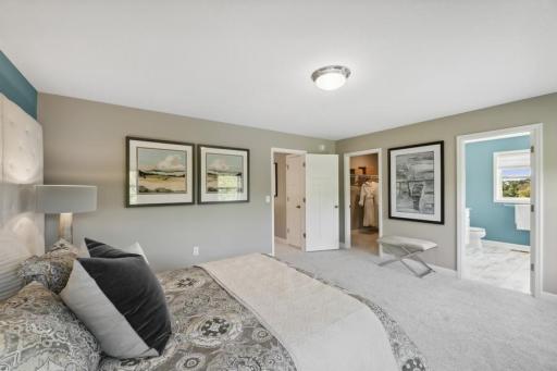 (Photo of decorated model, colors and features will vary) Owner's suite and a views into the walk-in closet and full bath.