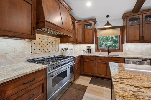 This beautifully updated kitchen includes custom Adler cabinets, granite counter tops, and an Italian Ilve 7 burner, double oven range - just to name a few of the WOW factors the second you step into your new home