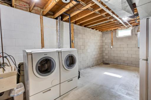 Meticulously clean laundry room with extra room for storage