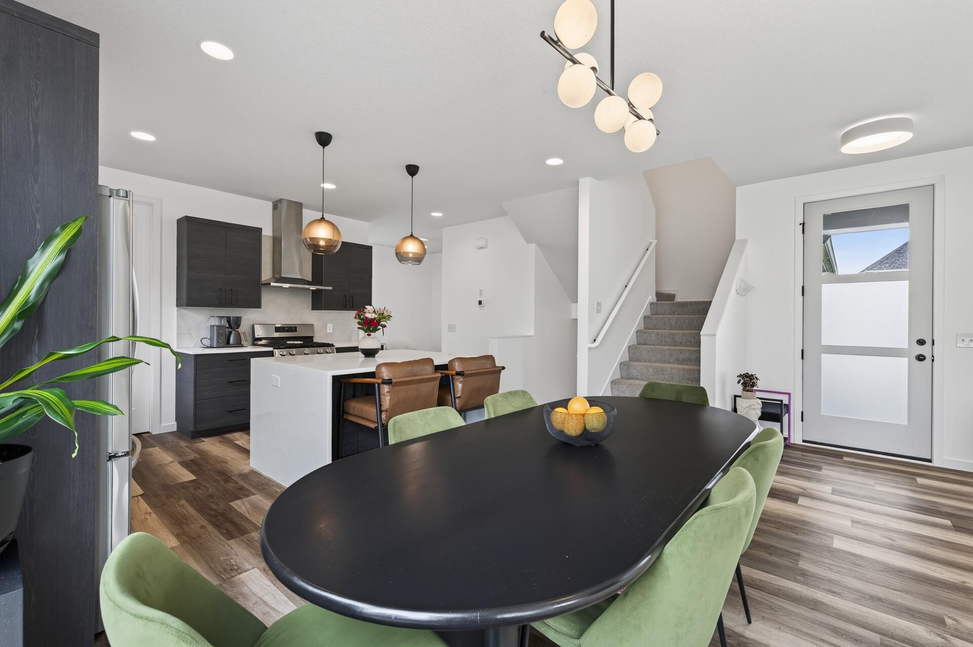 Another angle of dining and kitchen standing by the patio door.