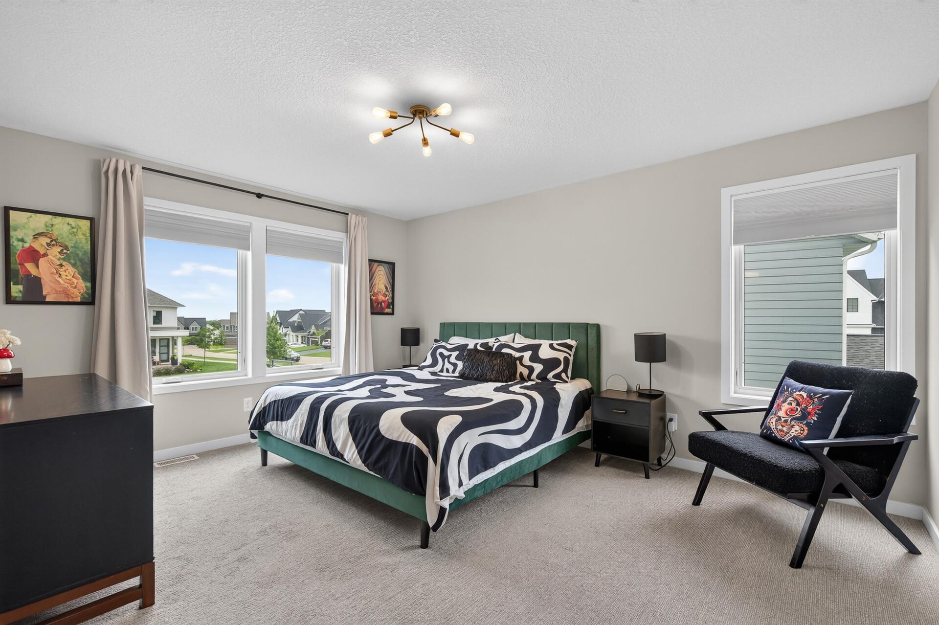 2nd level spacious primary bedroom with en-suite bathroom and walk-in closet.
