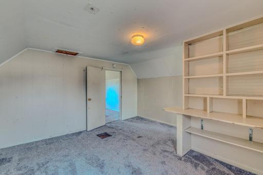 This bedroom offers custom built in bookshelf/desk, great for school or office work.