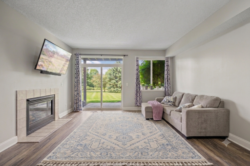 Large windows, patio door bring in a ton of natural light. Walkout to private patio over looking green space. (Virtual staging has been used to help highlight this home's features)