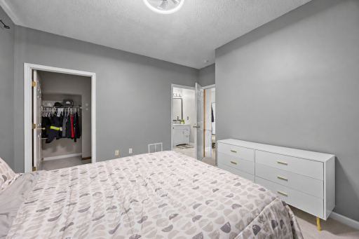 Primary Bedroom with walk-in closet and private, 3/4 bathroom. (Virtual staging has been used to help highlight this home's features)