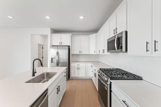 (Photo of a similar home, actual finishes may vary) Enjoy casual meals and seating at the breakfast bar extension