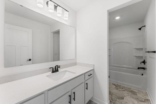 (Photo of a similar home, actual finishes may vary) This full-sized bathroom features a wide vanity that can close off from the shower-tub combination, allowing multiple residents to get ready for the day and night.