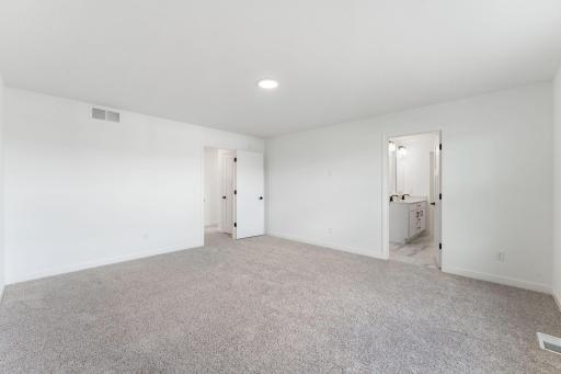 (Photo of a similar home, actual finishes may vary) The ownerâs suite is a blank canvas ready for a personal touch