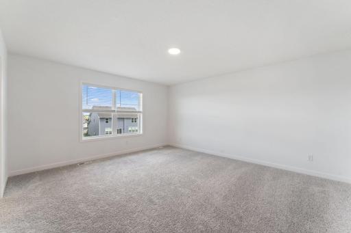 (Photo of a similar home, actual finishes may vary) The ownerâs suite is a tranquil haven tucked into a private rear corner on the second floor, offering access to a private bathroom and walk-in closet.