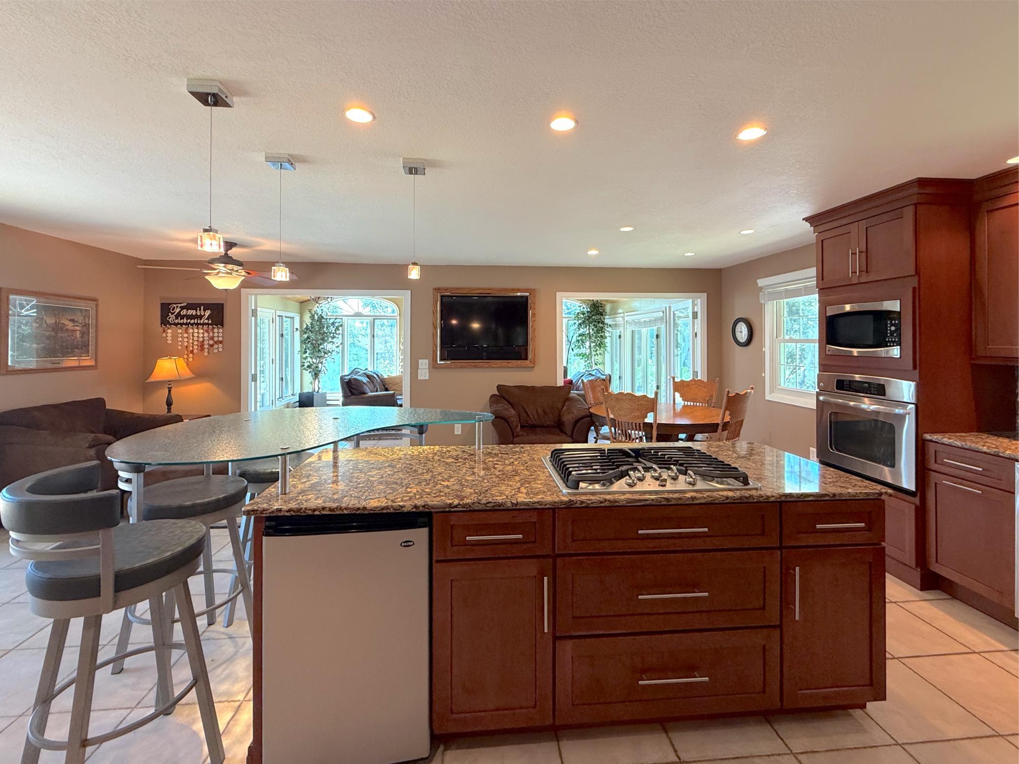 Thoughtful design, pendant lights, gas stove, ample storage, and a spacious island with seating, make this a space everyone will naturally gather around.