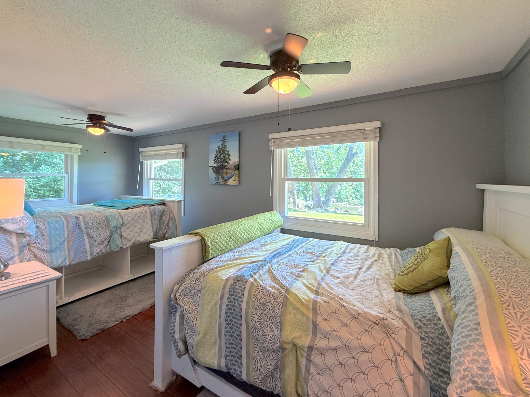Designed with flexibility in mind, this generous bedroom provides plenty of sleeping space for guests while maintaining a bright, welcoming atmosphere.