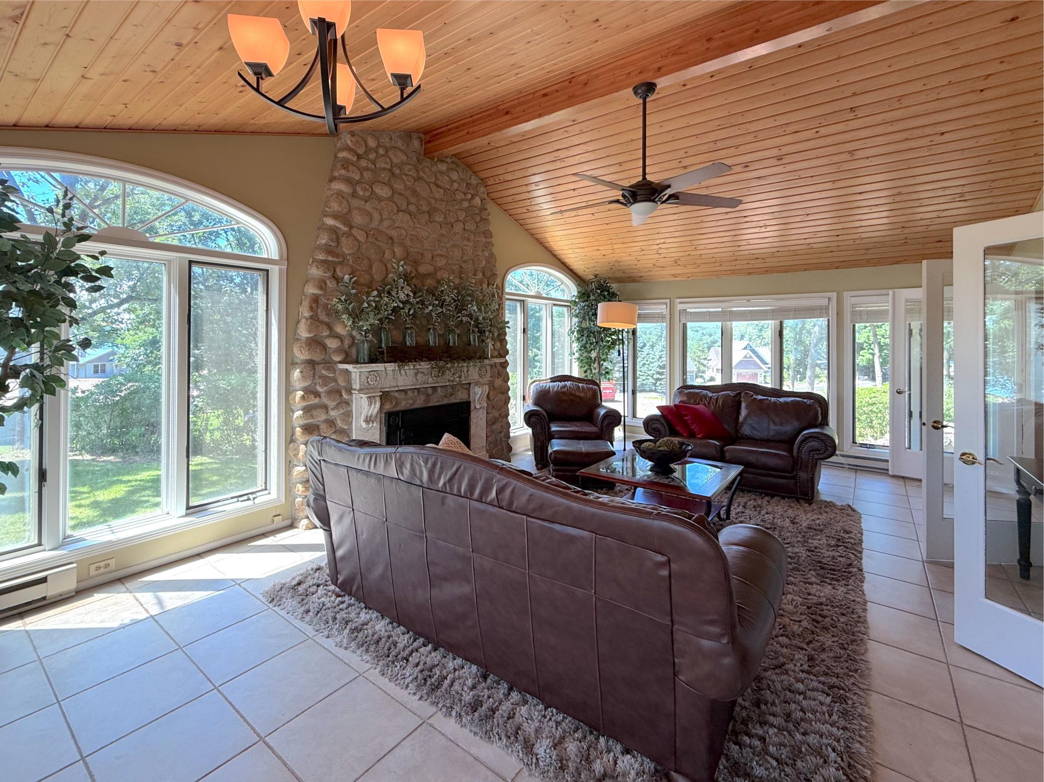 The vaulted wood ceiling, countless windows and impressive stone fireplace create a warm, welcoming atmosphere that perfectly complements the lakeside setting.