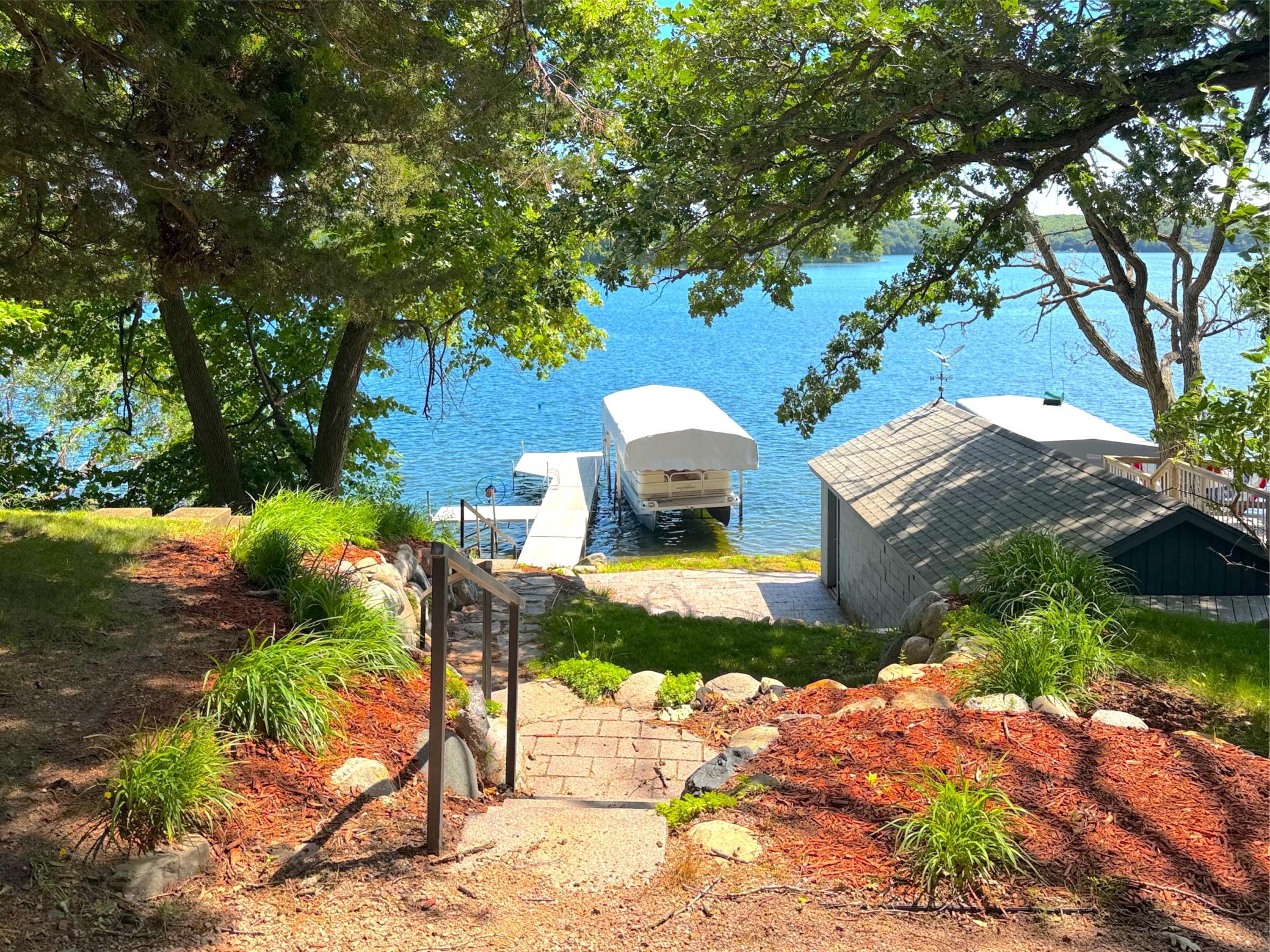 A spacious lakeside patio provides the perfect setting to enjoy the water's edge, entertain guests, or simply soak in the peaceful surroundings.