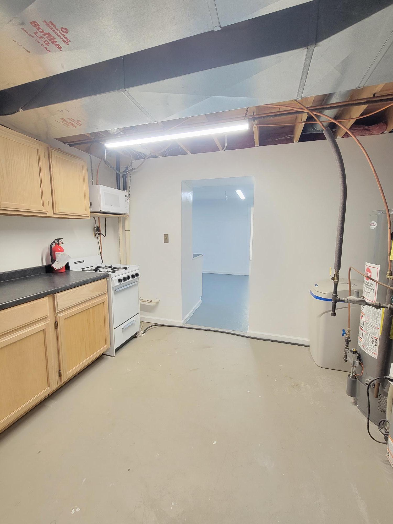 This is the utility room which also has an extra stove, microwave, and refrgerator around the corner