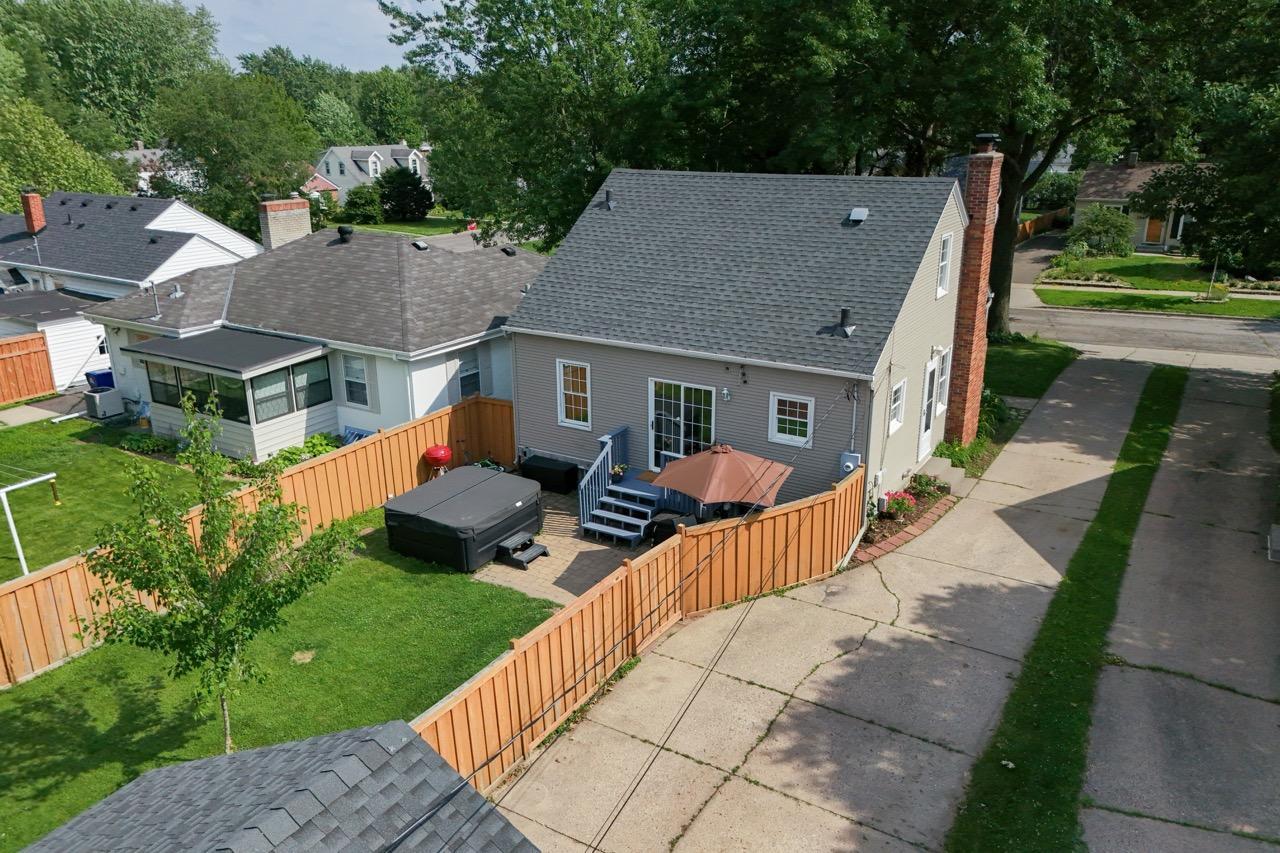 elevated shot of the hot tub, deck, driveway and back of house