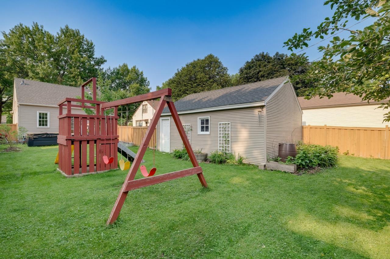 Backyard showing the extra tucked away area with the raspberry bushes