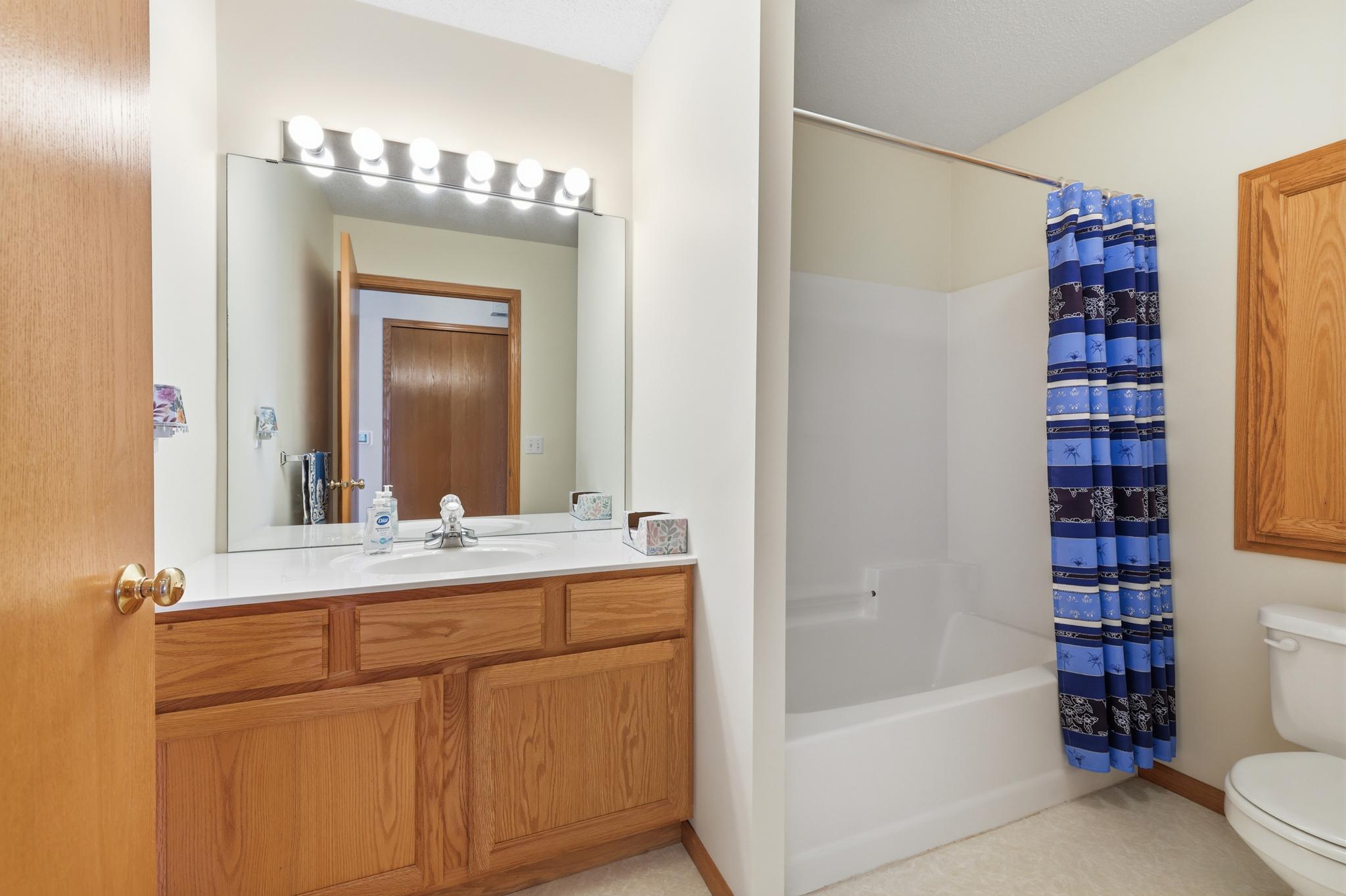 Full bathroom just off the living room and across from the second bedroom.