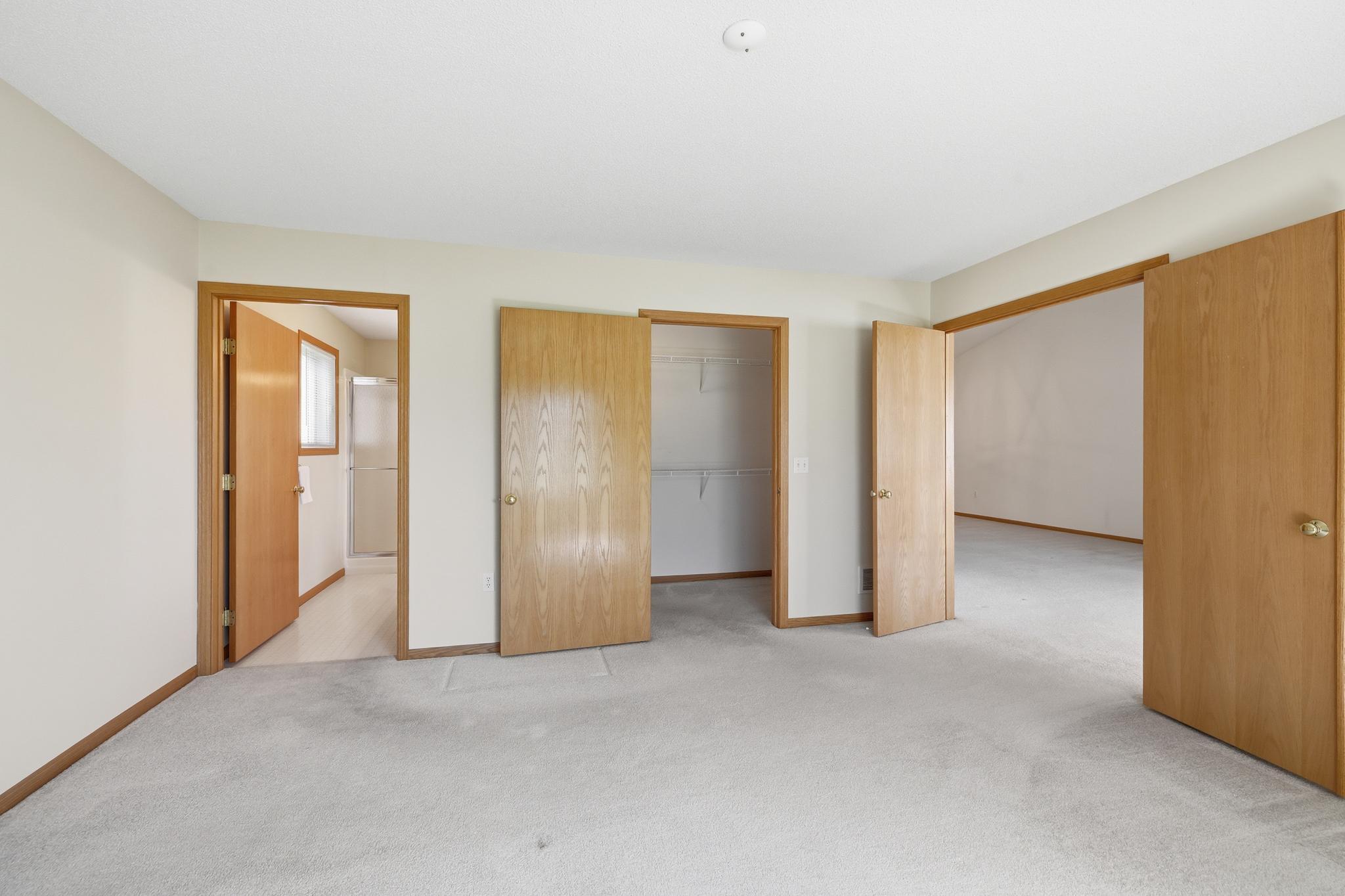 Primary bedroom suite with large walk-in closet and 3/4 bathroom en-suite.