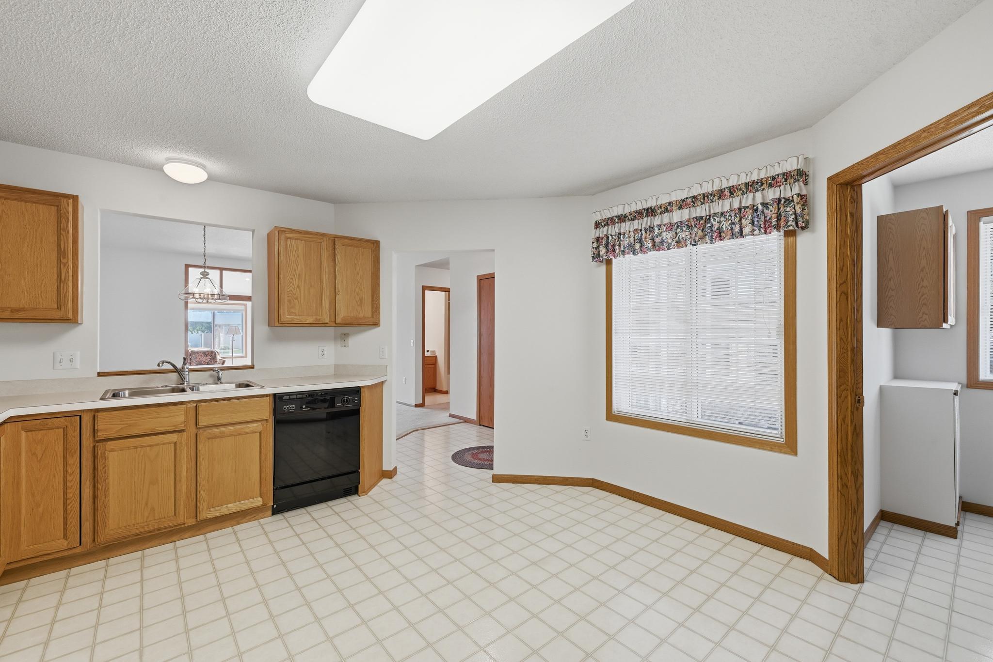 The kitchen features abundant cabinetry and generous countertop space, offering both functionality and plenty of room for meal prep and storage.