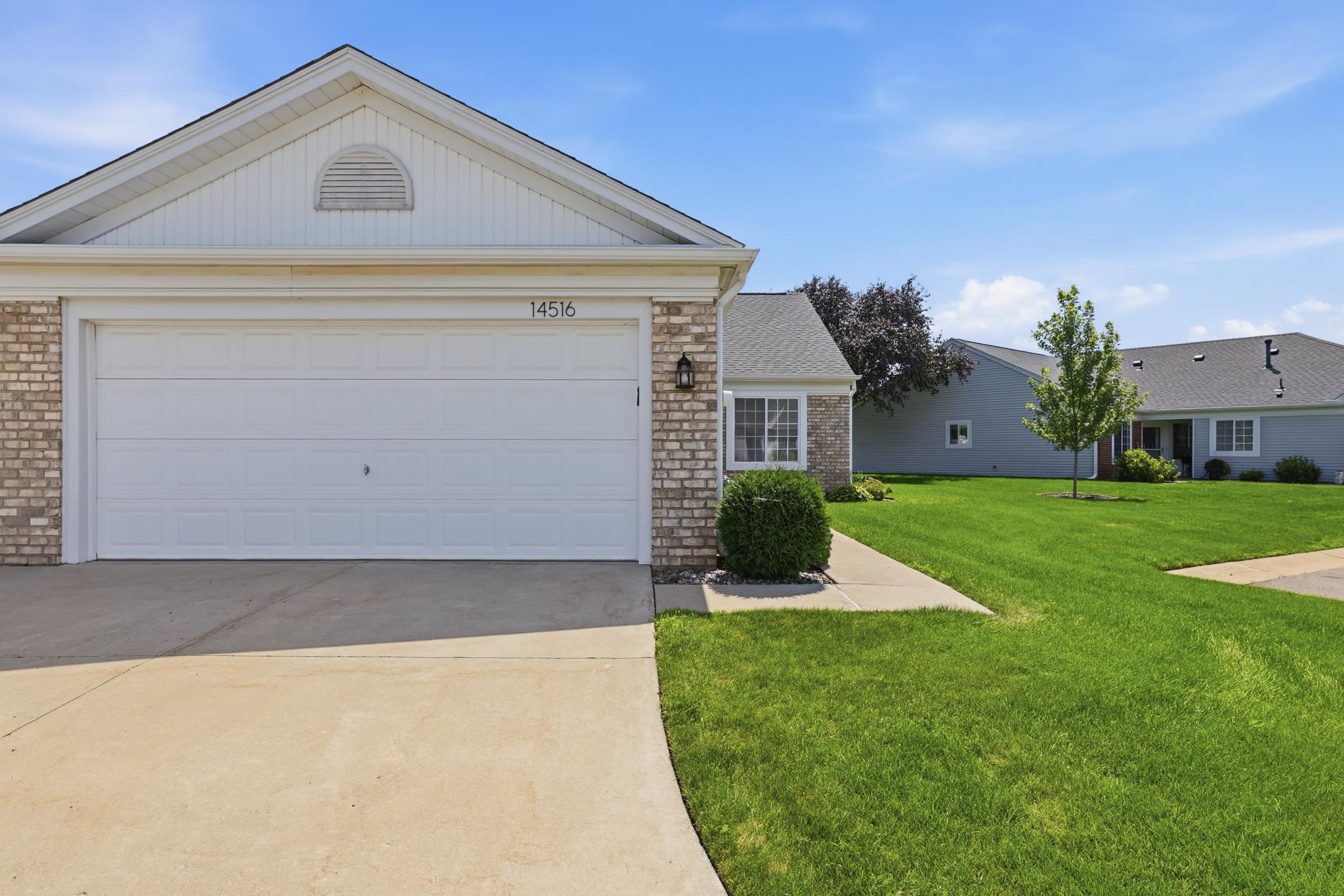 Durable concrete driveway offering clean curb appeal and low-maintenance convenience, with ample space for parking and easy everyday access.