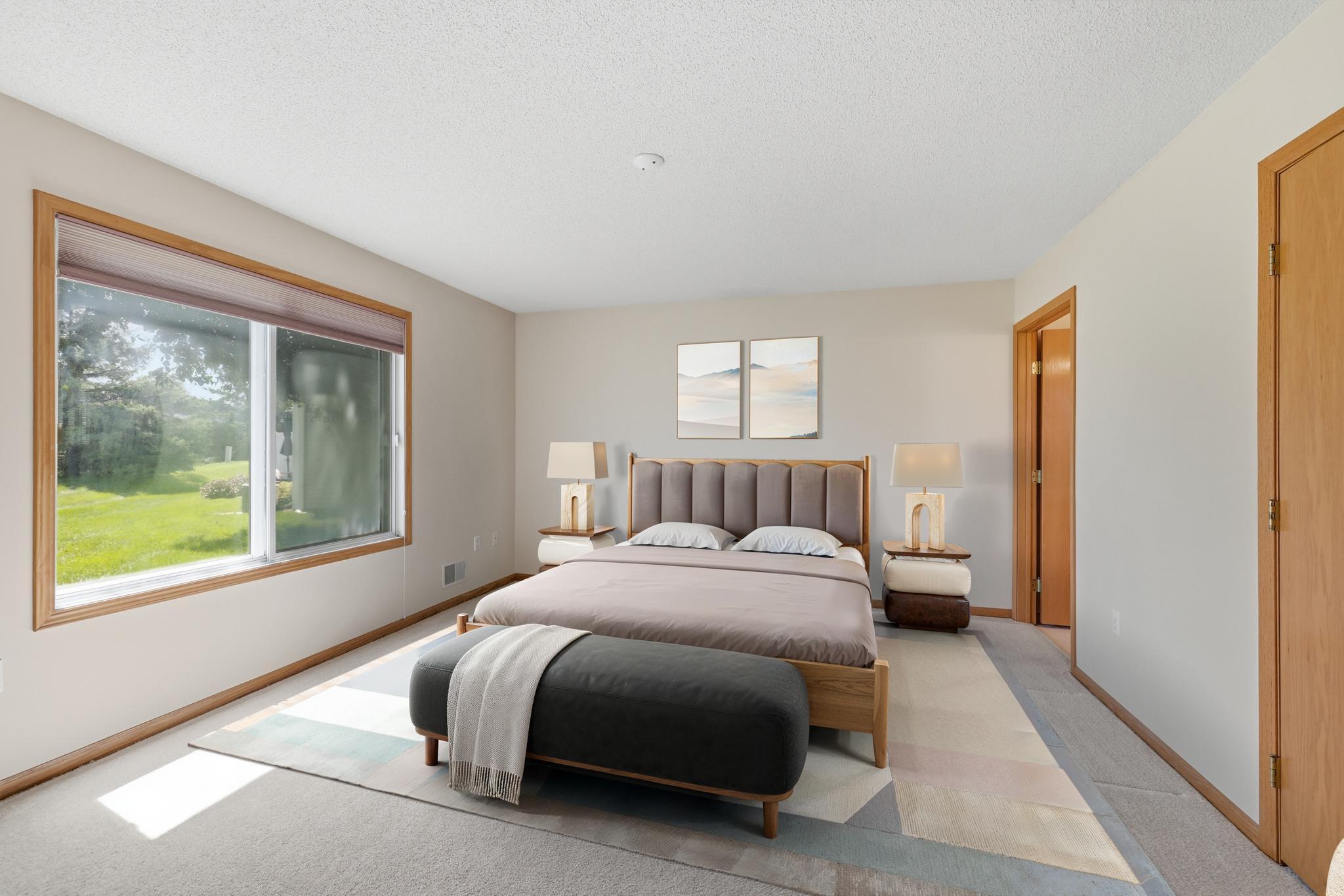 Primary bedroom suite virtually stagged. This spacious bedroom easily accommodates large furniture, offering both comfort and flexibility in layout.