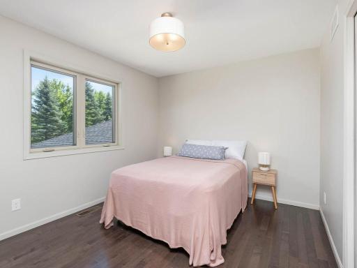 Additional upper-level bedroom 3 offers hardwood flooring, natural light, and comfortable closet space.