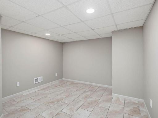 LL laundry room includes additional storage area w/tile flooring and recessed lighting.