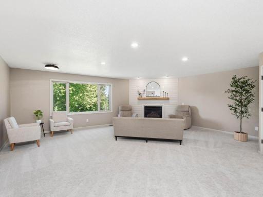 Spacious main-level living room features a gas FP, recessed lighting, and a Lg window overlooking the backyard.