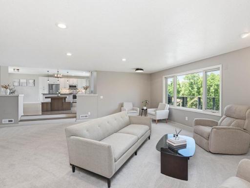Open sunken living room provides generous gathering space with comfortable connection to the kitchen and dining areas.