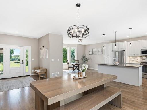 Expansive open-concept main level creates an easy flow between the kitchen, dining, and living areas with abundant natural light and generous space for everyday living and entertaining.