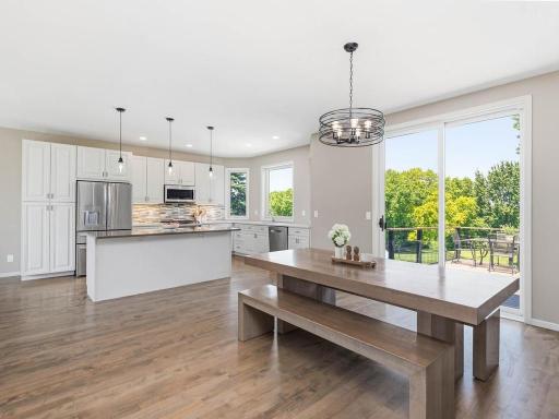 Open kitchen and dining areas connect to the cedar deck, creating easy flow for everyday living and outdoor entertaining.
