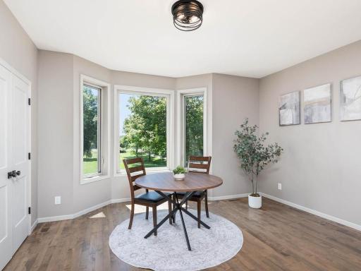 Informal dining area features Lg south-facing windows overlooking the expansive lawn and mature trees while connecting comfortably to the kitchen and main living spaces.