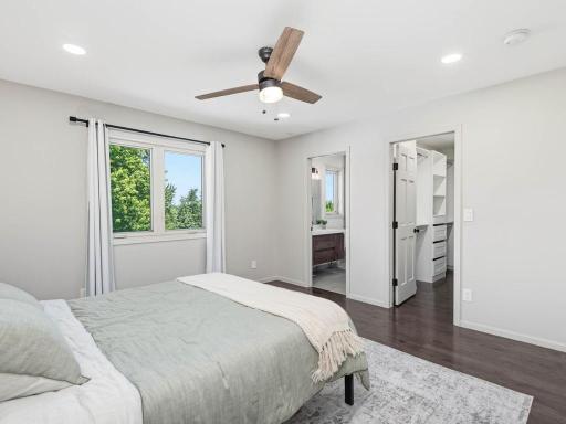 Primary bedroom provides comfortable space with direct access to the finished walk-in closet and private bath.