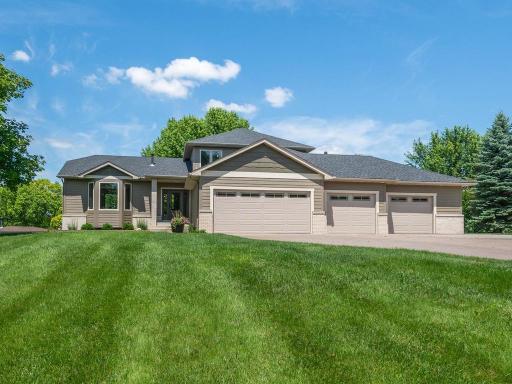 Home features a heated 4-car garage with abundant additional parking and a covered front porch to welcome guests.