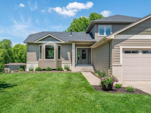Welcoming front entry is complemented by updated LP SmartSide siding, newer windows, and an architectural shingle roof.