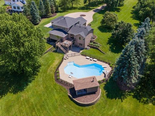 Private pool area, expansive lawn, and mature tree coverage throughout the 2.023-acre setting.