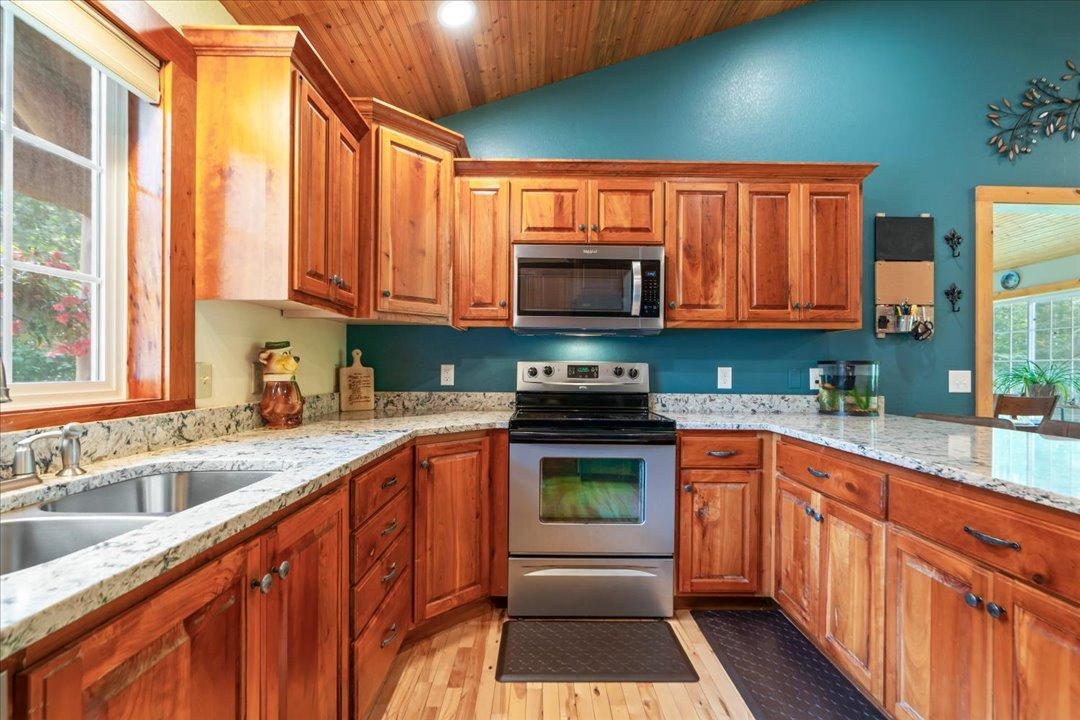 Custom Knotty Alder Cabinetry with Stainless Steel Appliances