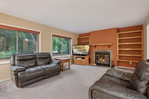 Primary Livingroom with full windows overlooking space with fireplace.
