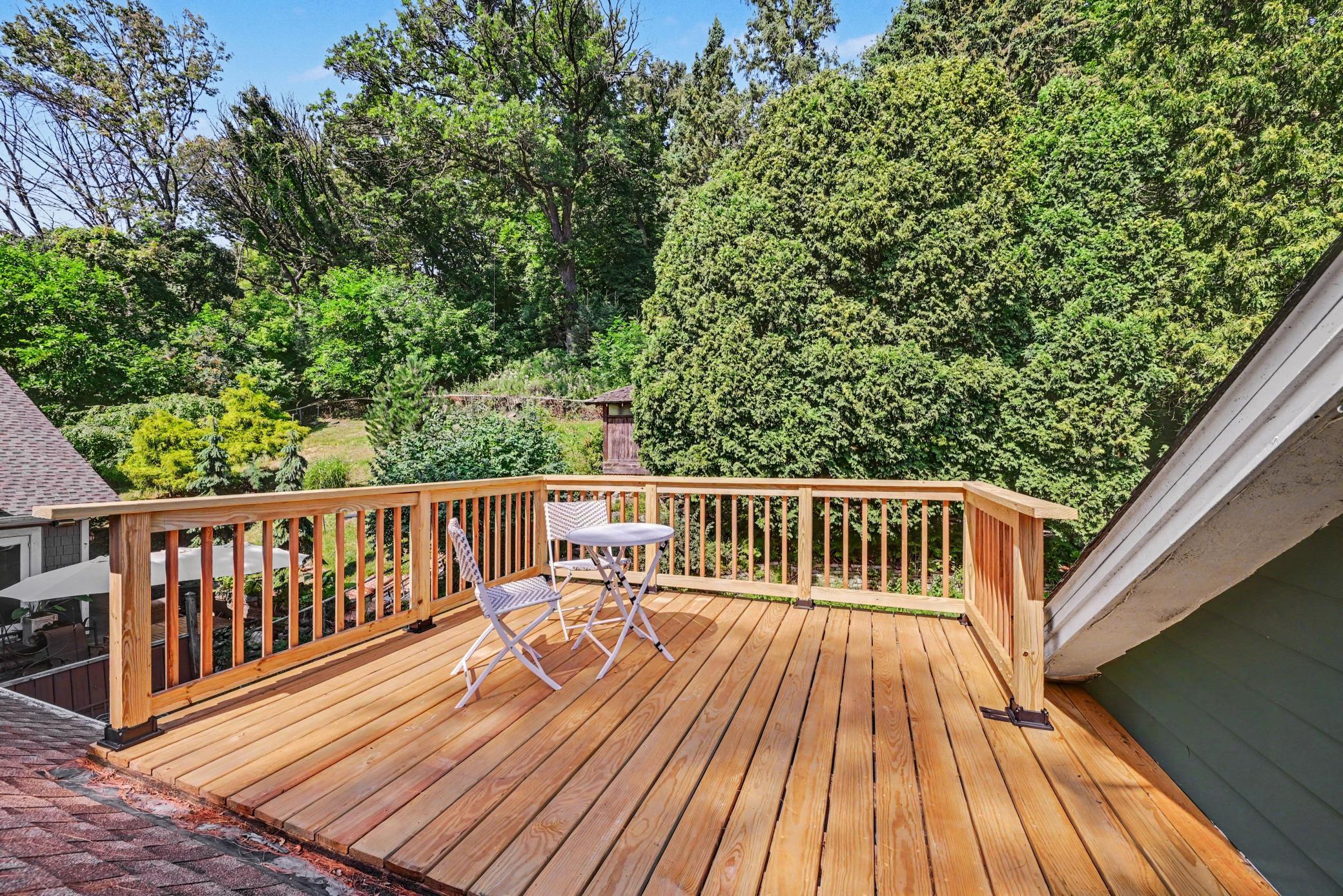 Wooded backyard seen from upper deck.eck off upper level primary bedroom