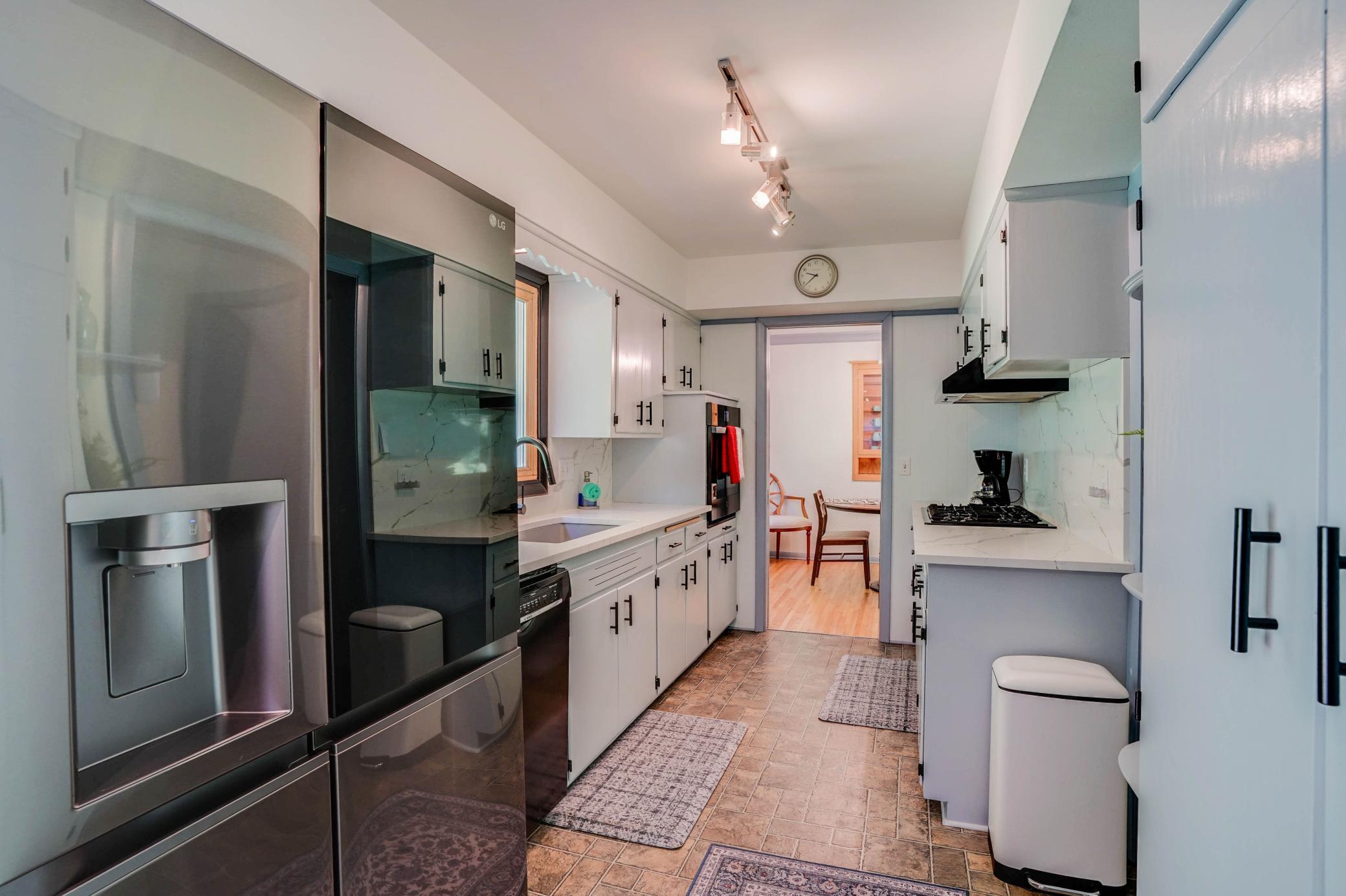 Kitchen w/newer stainless steel fridge