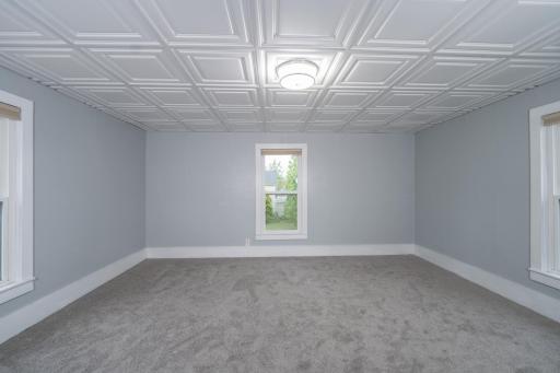 Upper level Primary Bedroom w/new carpeting & ceiling tiles.