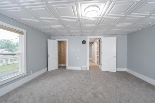 Upper level Primary Bedroom w/new carpeting and ceiling tiles.