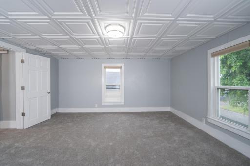 Upper level Primary Bedroom w/new carpeting and ceiling tiles.