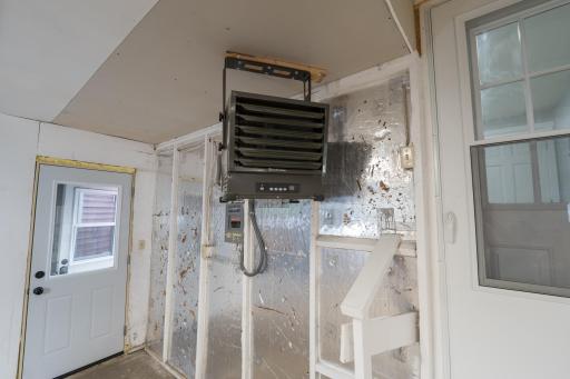 Workshop heater. Door on the right goes into the house. Service door straight ahead leads to garage.