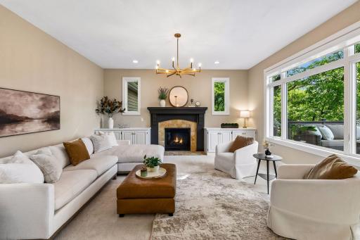 Modern, inviting, and warm, the living room features a cozy gas fireplace, overlooks the deck, and captures beautiful lake views.