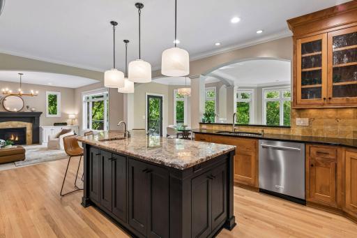 The heart of the home, this spotless kitchen features Wolf appliances, newly refinished granite countertops, beautifully refinished hardwood floors, and cabinets galore.