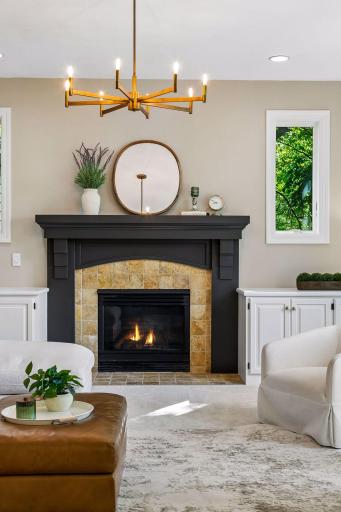 Modern, inviting, and warm, the living room features a cozy gas fireplace, overlooks the deck, and captures beautiful lake views.