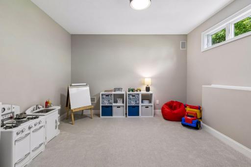 More views, more space, and more possibilities. The walkout lower level features a cozy family room with a gas fireplace and wet bar, a guest bedroom, bathroom, gym, and flexible play space that could easily be converted into an additional bedroom if