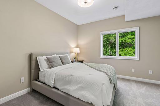 More views, more space, and more possibilities. The walkout lower level features a cozy family room with a gas fireplace and wet bar, a guest bedroom, bathroom, gym, and flexible play space that could easily be converted into an additional bedroom if