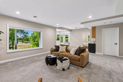 More views, more space, and more possibilities. The walkout lower level features a cozy family room with a gas fireplace and wet bar, a guest bedroom, bathroom, gym, and flexible play space that could easily be converted into an additional bedroom if