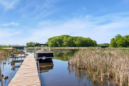 Shared dock with one neighboring property. Neighbor has expressed willingness to extend the dock if additional space is desired. Shared ownership helps reduce maintenance, repair, and improvement costs by splitting expenses between both owners.